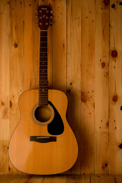 istock Acoustic guitar on wood background 654003238