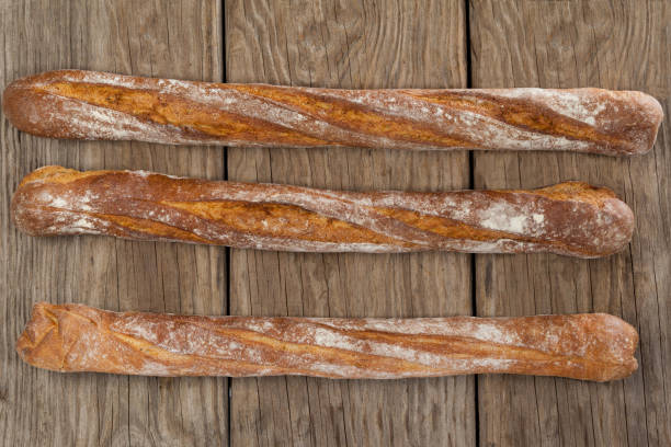 istock Baguettes on wooden background 654003762
