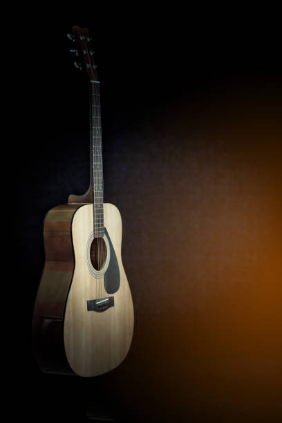 istock Acoustic guitar on a black background with copy space 654003794