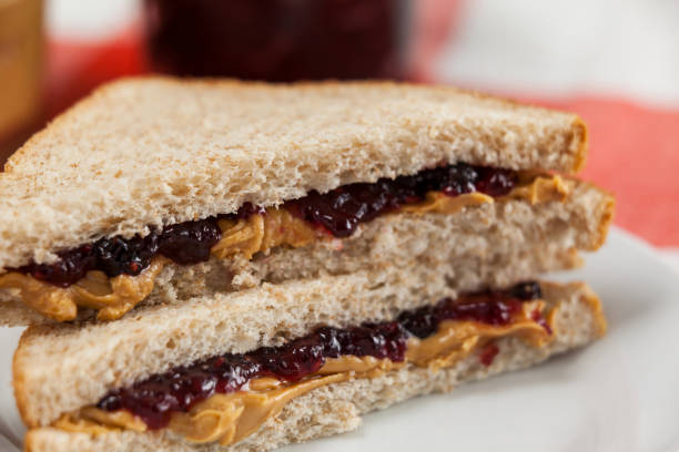 Bread sandwich with jam and peanut butter Close-up of bread sandwich with jam and peanut butter peanut butter and jelly sandwich stock pictures, royalty-free photos & images
