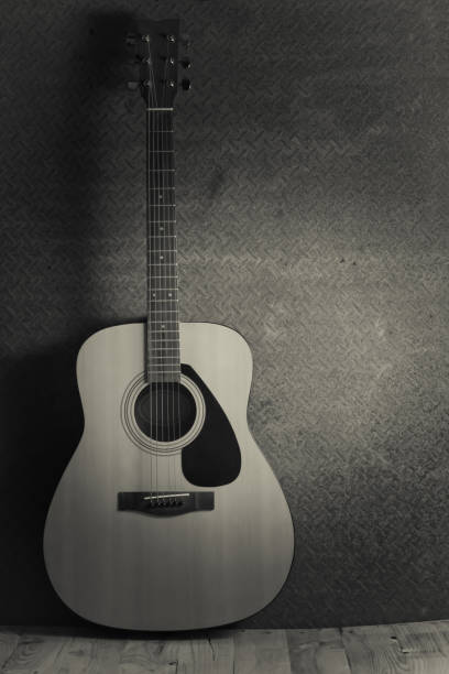 istock Acoustic guitar on old steel background ,black and white 654006212