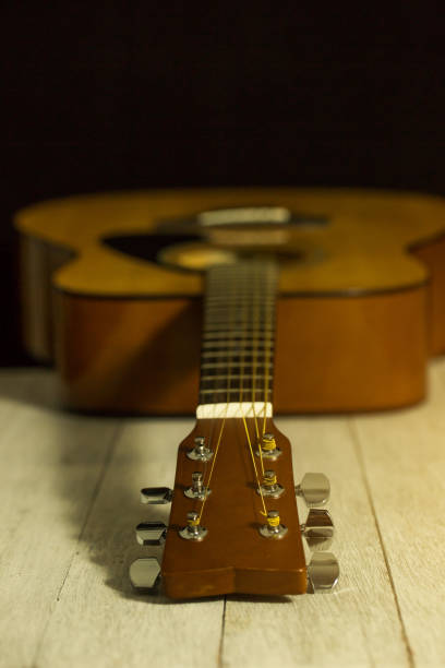 istock Acoustic guitar on black background 654006244