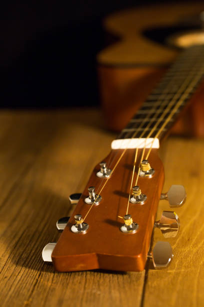 istock Acoustic guitar on wood background with copy space,head part 654006396