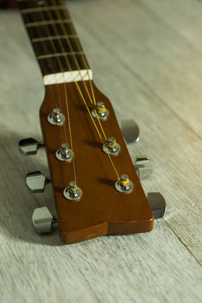 istock Acoustic guitar on wood background with copy space,head part 654006520