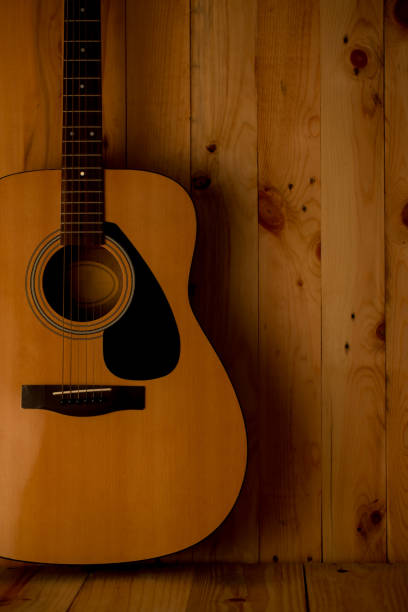 istock Acoustic guitar on wood background 654006998