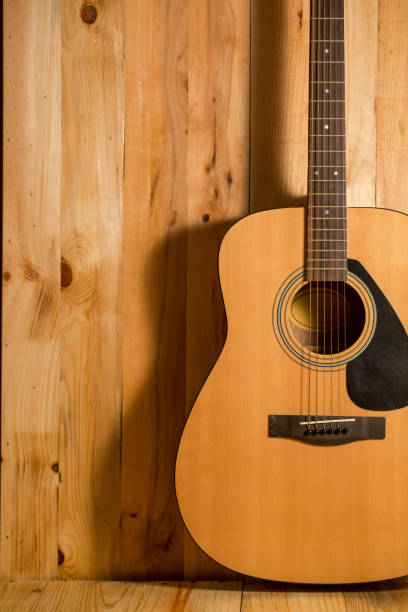 istock Acoustic guitar on wood background 654007102