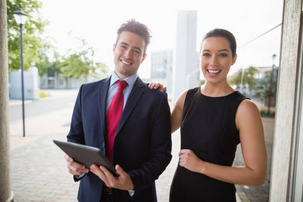 istock Businessman and colleague holding digital tablet 654010036