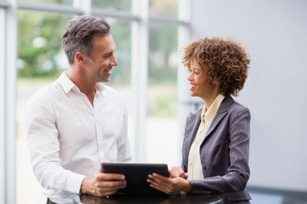 istock Business executives discussing over digital tablet 654010098