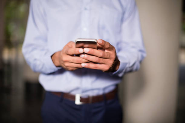 istock Business executive holding mobile phone 654010404