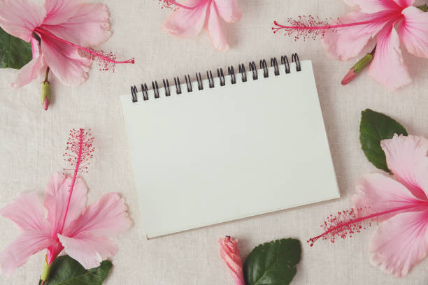 istock notebook with Pink Hibiscus flowers on linen, copy space background, selective focus, vintage tone 654013594