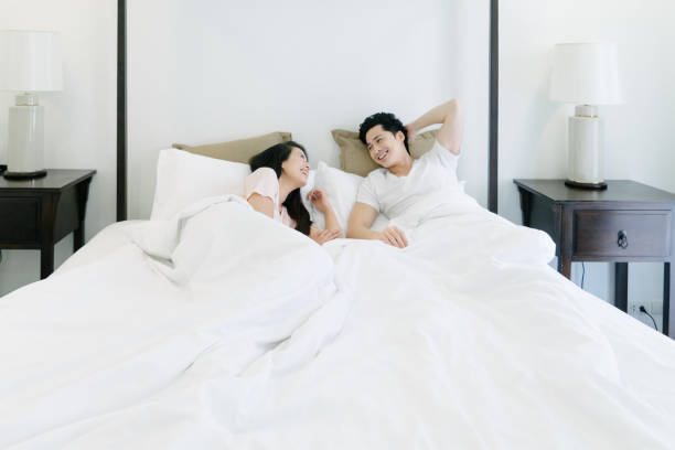 Young happy couple, waking up in the morning stock photo