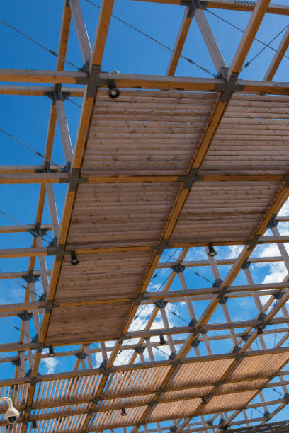 istock Wooden Ceiling Structure: Building with Modern Architectural Design and Blue Sky in background 654019748