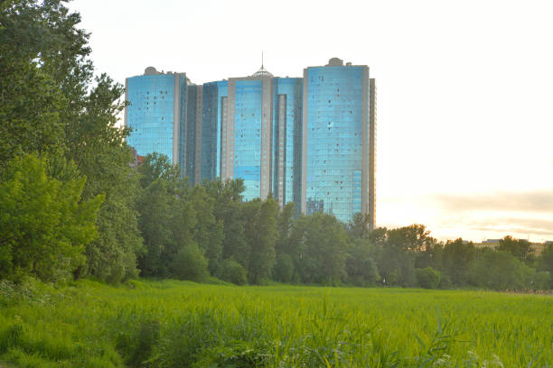 Summer landscape with residential skyscraper on the outskirts of St. Petersburg, Russia.
