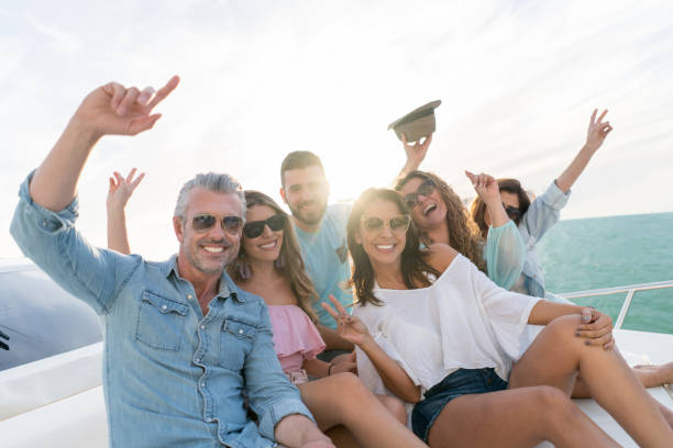 istock Happy group of people sailing on a yacht 654041704