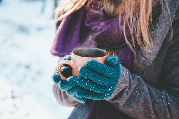 istock Young woman drinking hot drink 654043836