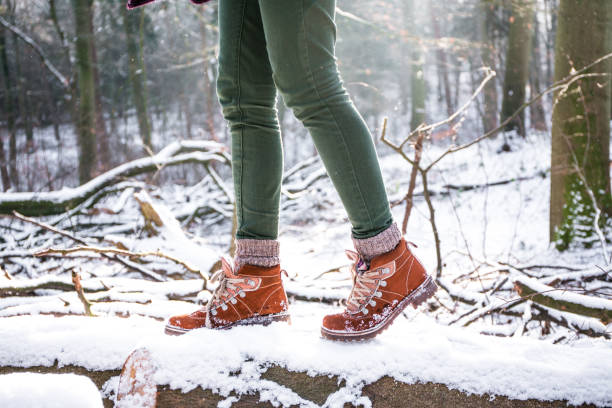 Forest walk A woman hiking in the forest at the snowstorm snow hiking stock pictures, royalty-free photos & images