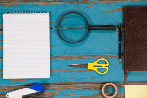 istock Notepad, magnifying glass, scissor, stapler, pen sellotape and diary 654044468
