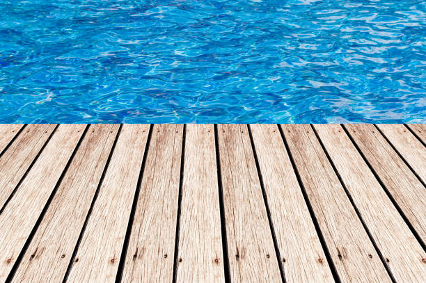 istock Wood table top on Surface water in pool background - can be used for display or montage your products 654049220