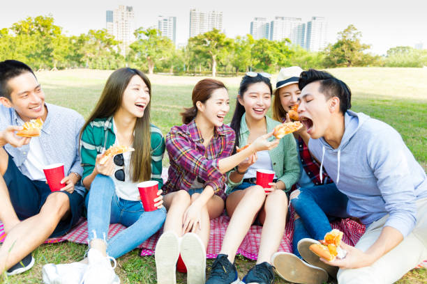istock happy young friends enjoying  healthy picnic 654051732