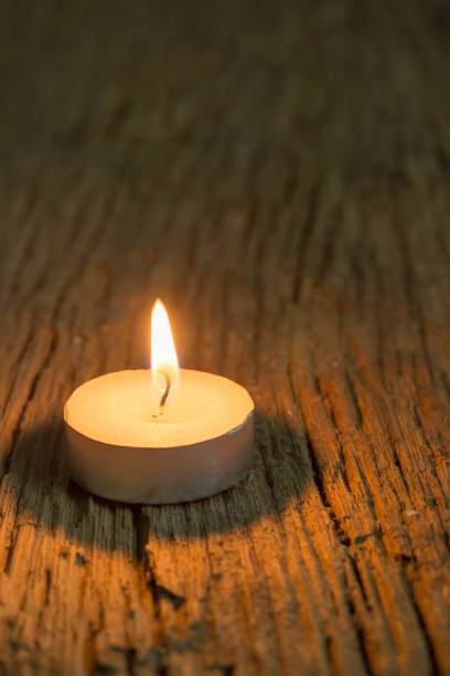 candle light in dark on wood texture