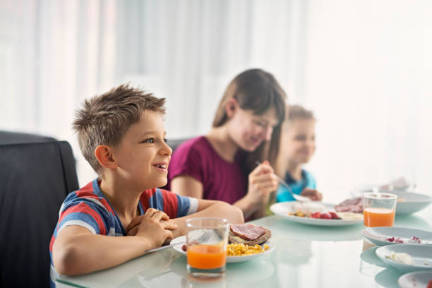 istock Kids eating breakfast on sunny morning 654054998