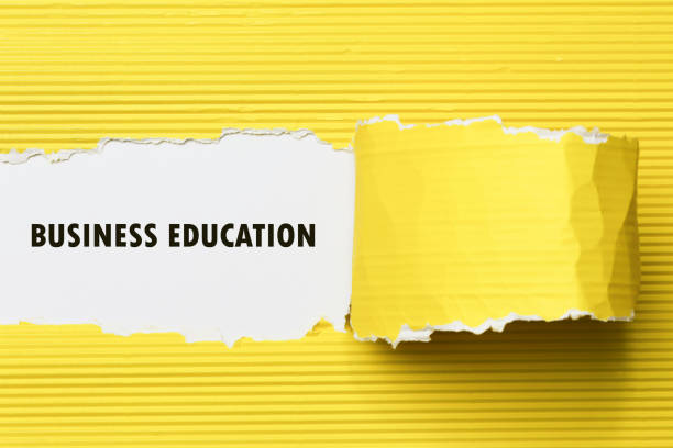 istock business education appearing behind torn paper. 654061264