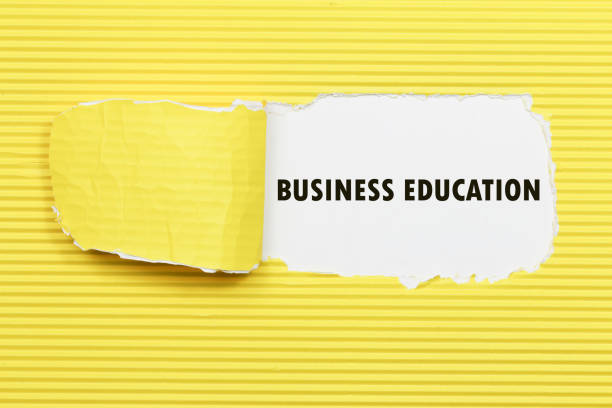 istock business education appearing behind torn paper. 654061266