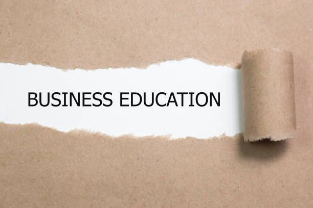 istock business education appearing behind torn paper. 654061272