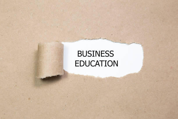 istock business education appearing behind torn paper. 654061284