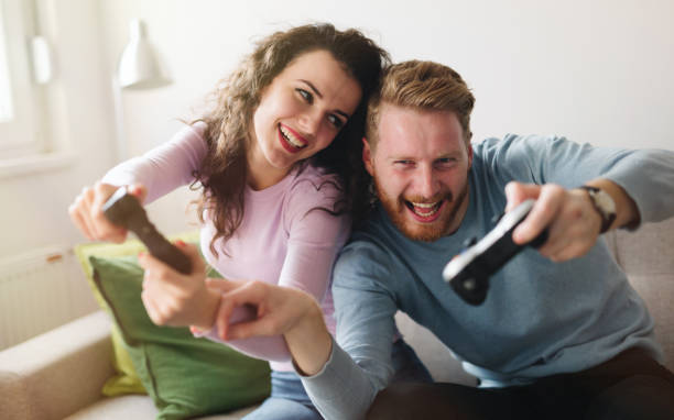 istock Happy couple playing video games  on console and having fun 654062250