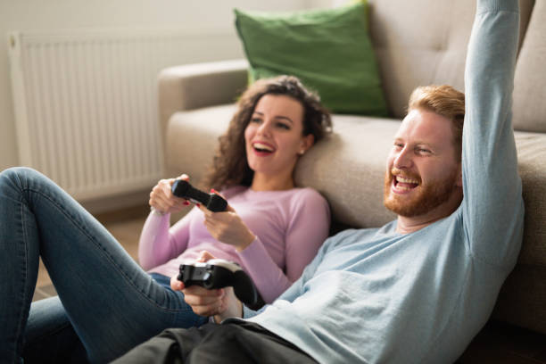 istock Beautiful couple playing video games on console having fun 654062422