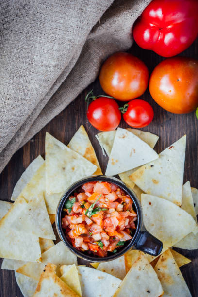 istock Hot mexican salsa - spicy dip with nachos - chips from corn 654062468