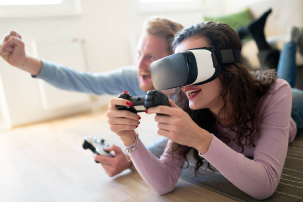 istock Couple playing games and loving VR as future tech 654062526