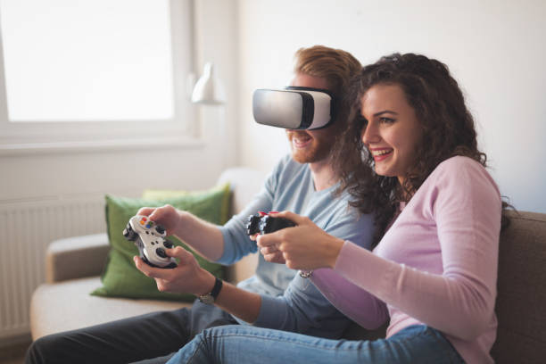 istock Couple playing games and loving VR as future tech 654062728