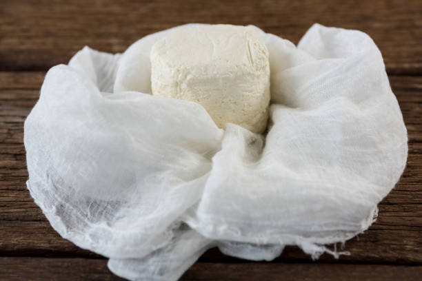 istock Cottage cheese in white cloth on wooden board 654063190