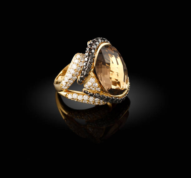 istock Gold ring with a brilliants on a black background 654067614