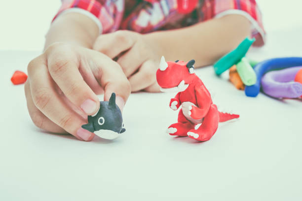 istock Child molding model clay. Strengthen the imagination. Vintage tone effect. 654069426