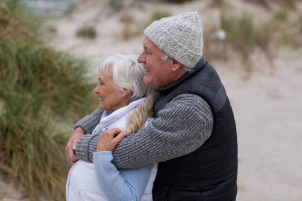 istock Senior couple standing together on the beach 654069844