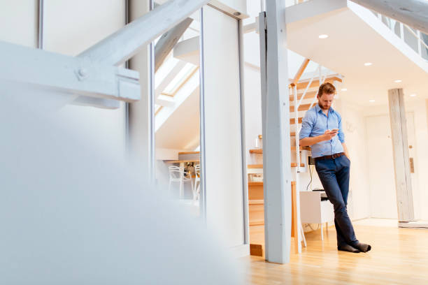 istock Handsome business using phone at home dressed in shirt 654073108