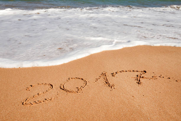 istock Happy New Year 2017 on the beach 654073480