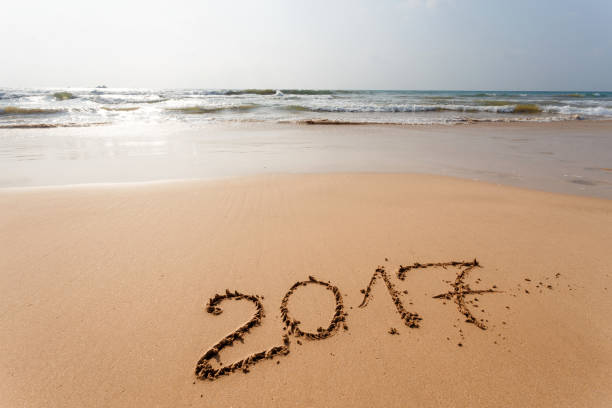 istock Happy New Year 2017 on the beach 654073518