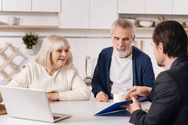 istock Involved senior couple having conversation with Real Estate Agent at home 654079202