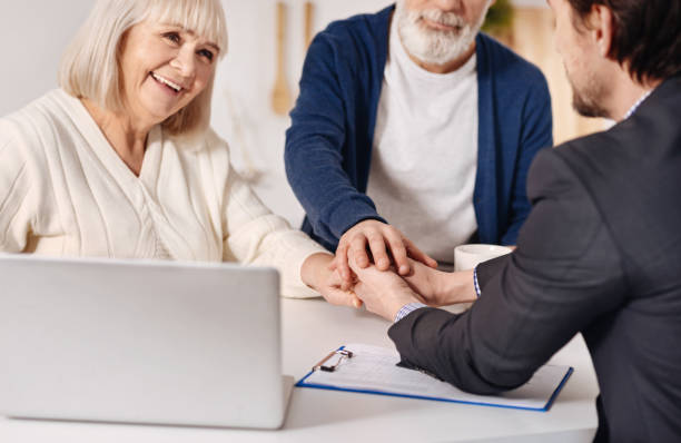 istock Real estate agent working with elderly couple of customers 654079476