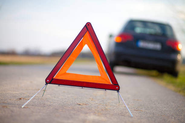 istock breakdown triangle stands near a broken car 654080172