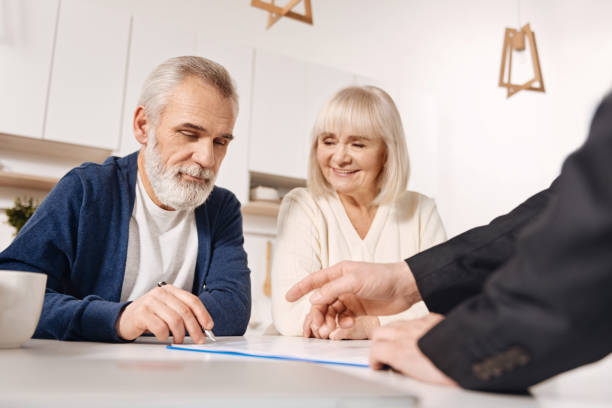 istock Resolute elderly couple signing agreement at home 654082734