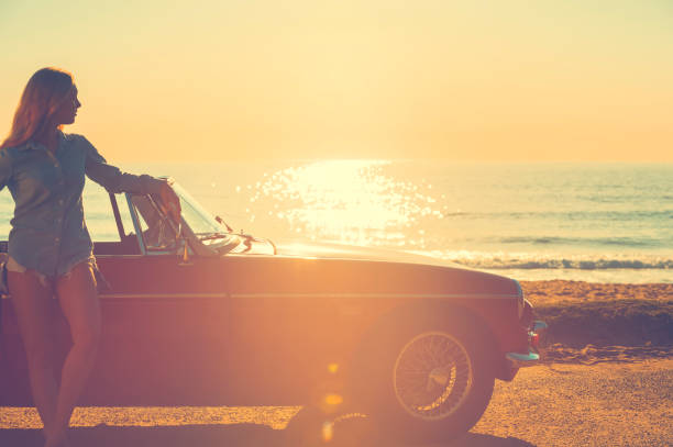 istock Woman relaxing beside a car. 654084728