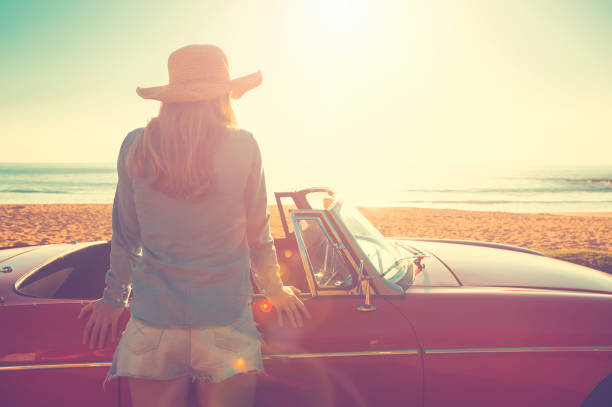 istock Woman relaxing beside a car. 654084734