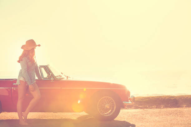 istock Woman relaxing beside a car. 654084768