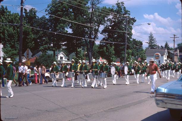 Belvidere, Illinois, USA, 1974. The citizens of Belvidere / Illinois celebrate the Independence Day with a parade. They stand along the N State St in the heart of Belvidere.