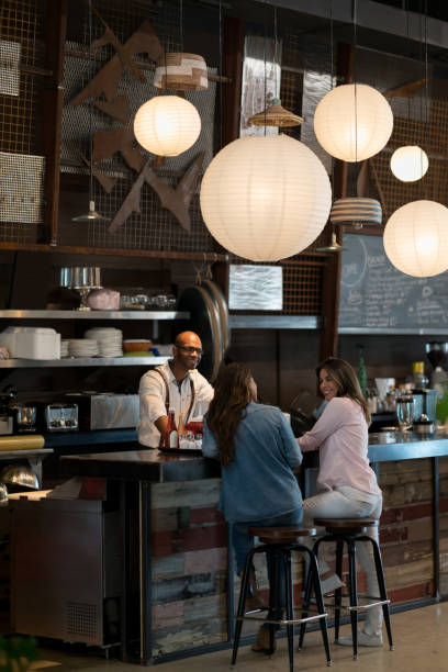 istock Women talking to waiter at a restaurant 654089636